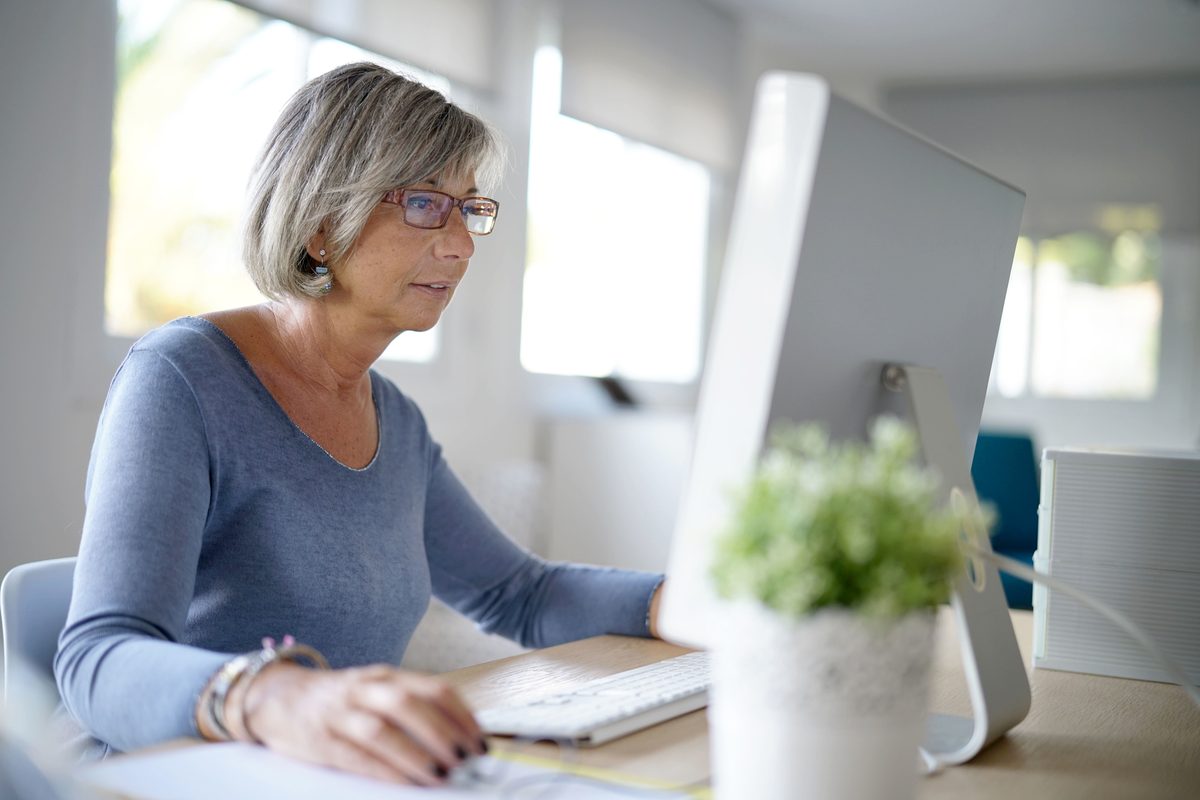 An office worker reviewing hours on a desktop computer